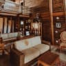 Sample stock photo of a light sofa in a wood-paneled living room